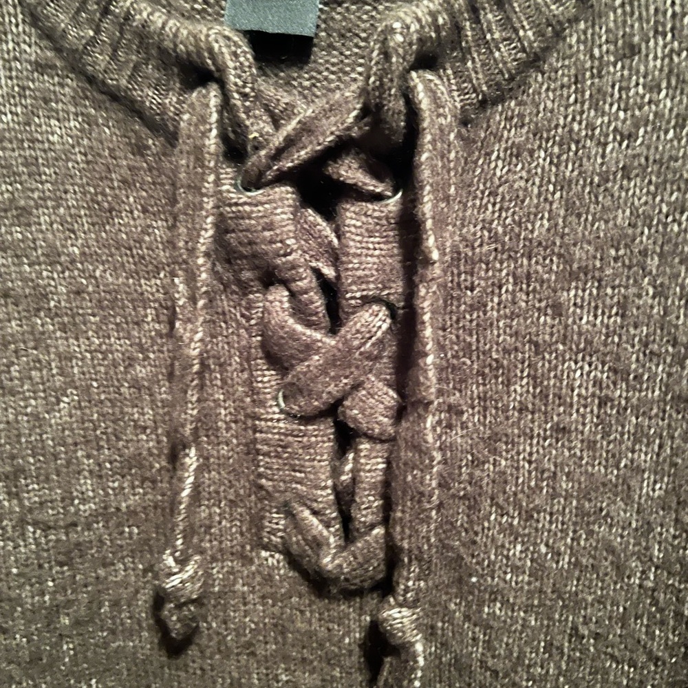 Cliche sweater with lace up neck.